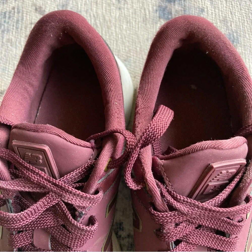 New Balance women’s Burgundy Sneakers with Gold Accent